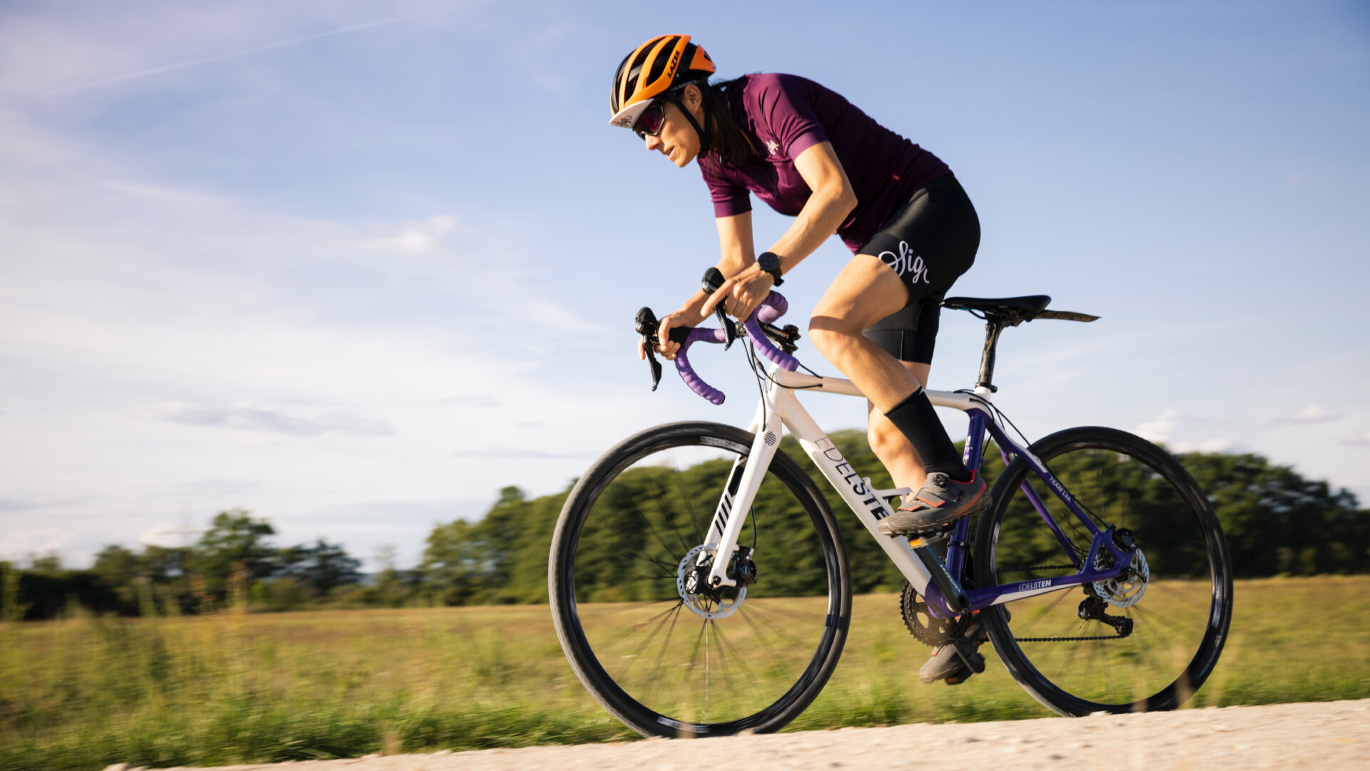 Woman sprinting out of the saddle on a gravel ride