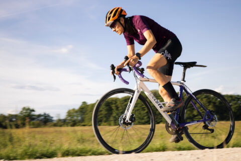 Woman sprinting out of the saddle on a gravel ride