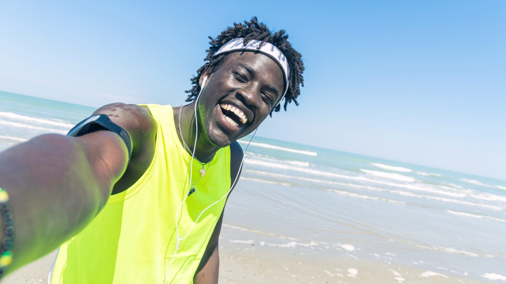 Athletic man taking a selfie at the beach.