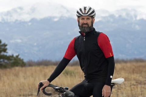 Jim Rutberg standing in front of Pikes Peak with his bike.