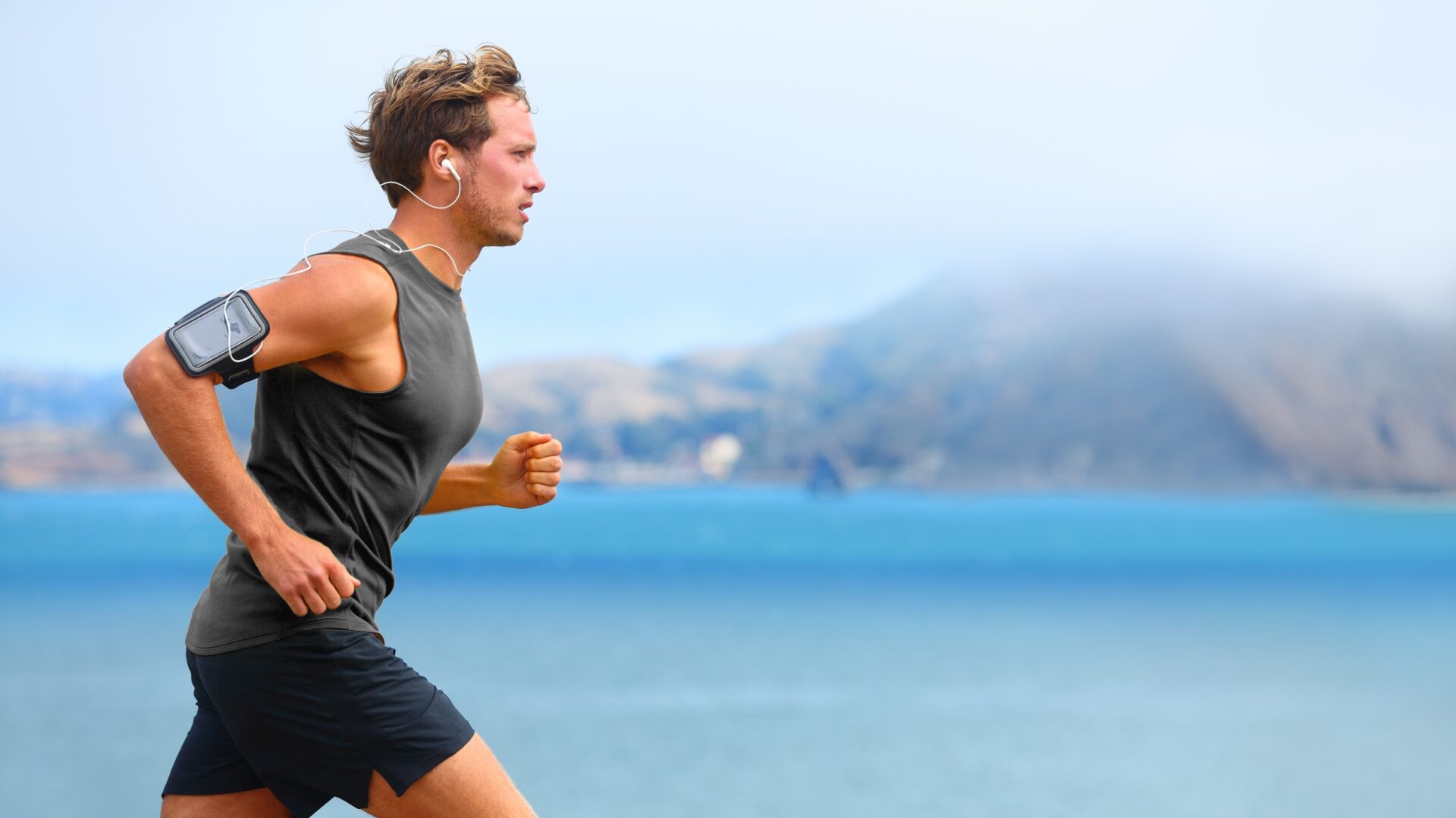 Man running along a coastline