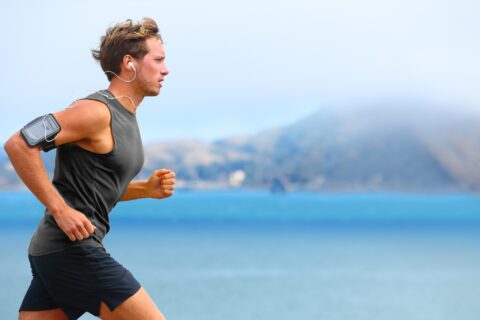 Man running along a coastline