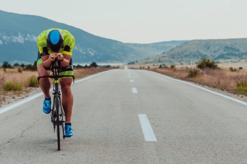 Triathlete sprinting on his bike on a back road