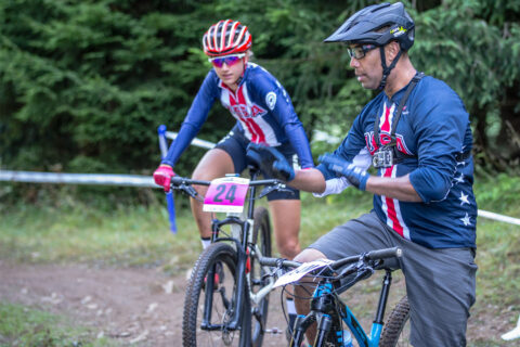 A USA Cycling mountain biking coach works with a Team USA athlete cyclist at the 2018 UCI MTB World Championships in Lenzerheide, Switzerland.