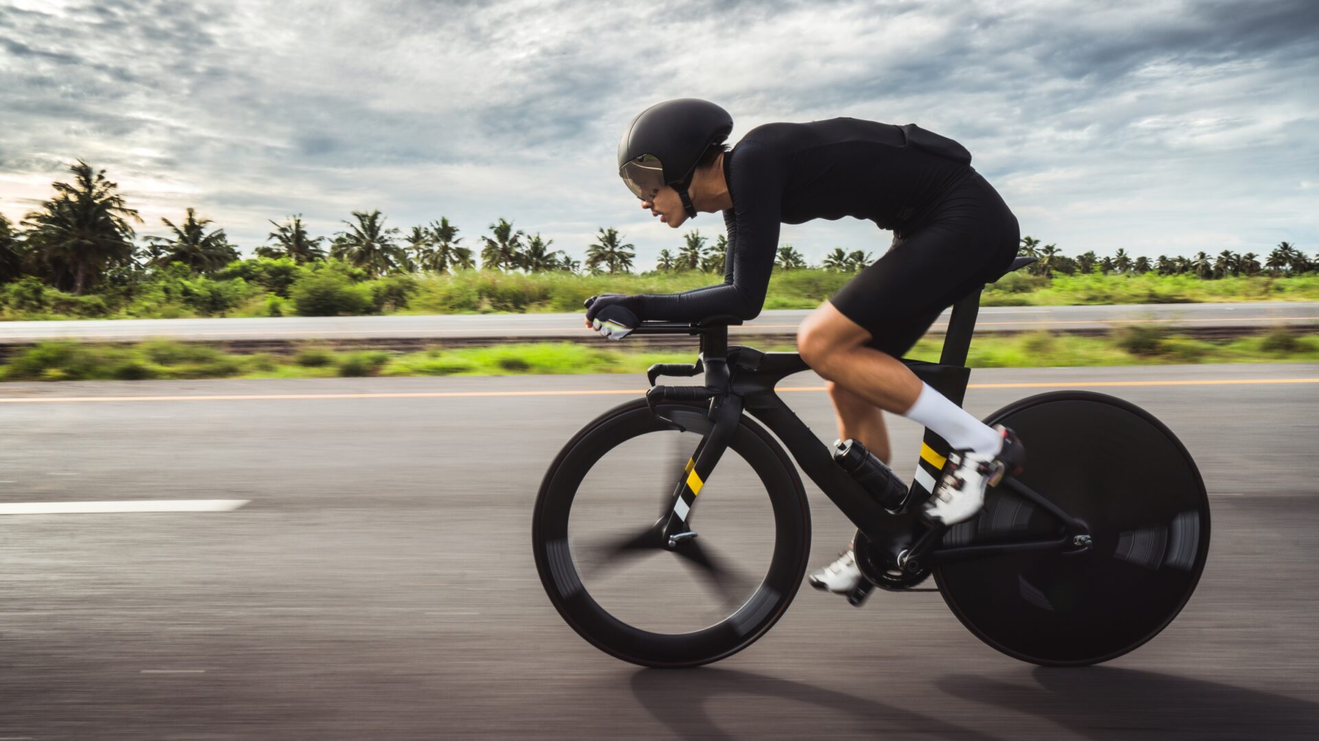 Male athlete time trialing on a bike