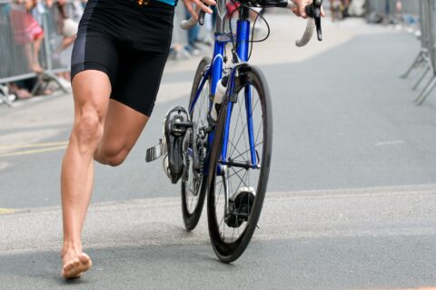 Athlete running through a triathlon transition from bike to run